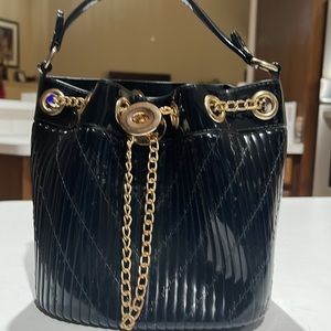 Bucket list or bucket bag? Black bag-heavy plastic with threaded design. W/Chain